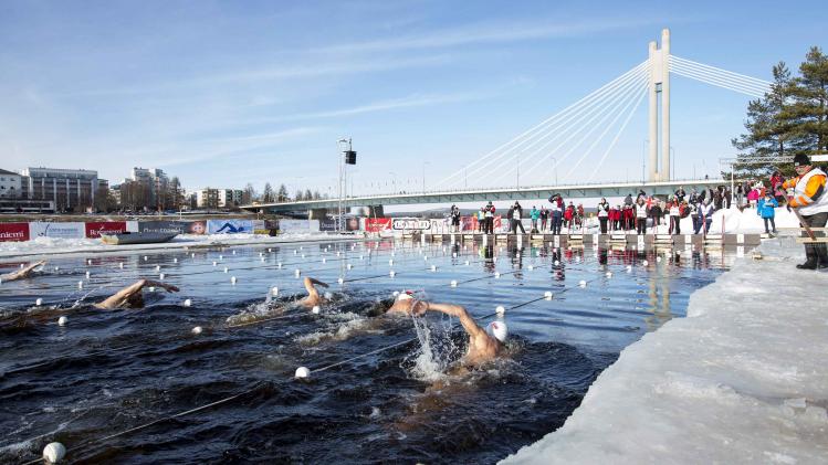 Swimmers compete during the Winter Swimming World Championships men's 450 metres race in Rovaniemi