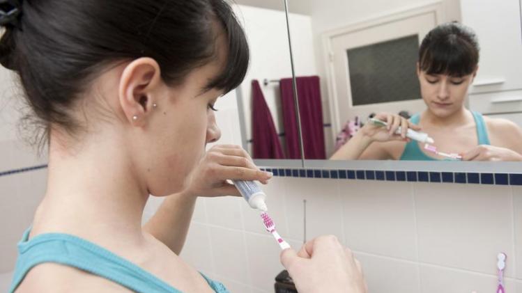 Young Woman brushing her teeth