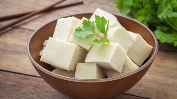 Tofu cubes in bowl and parsley