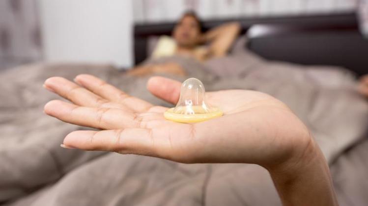 close-up-of-woman-holding-condom-248148