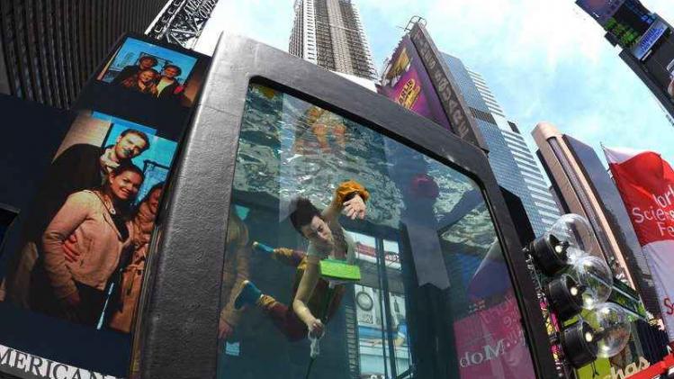 Performance in 12-ton water-filled glass aquarium in the middle of Times Square - part of World Science Festival