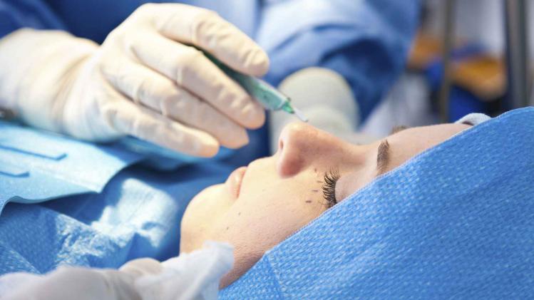 Closeup of woman having plastic surgery performed