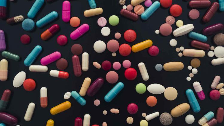 colorful pills on black background