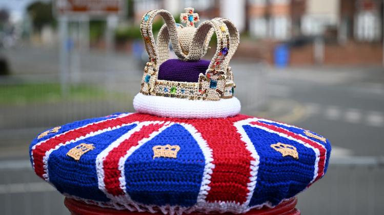 A_photograph_taken_on_May_2_2023_shows_a_knitted_crown_displayed_on_a_post_o