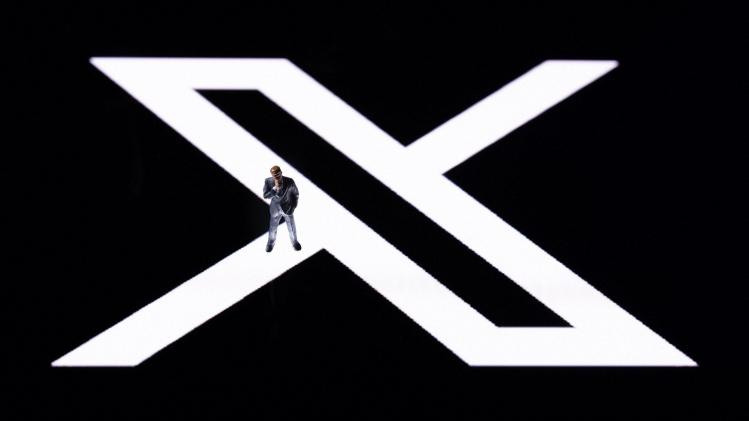 a_figurine_displayed_on_the_new_Twitter_logo_rebranded_as_X_reflected_in_smartph