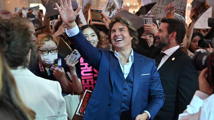 American_actor_Tom_Cruise_waves_to_fans_during_a_red_carpet_event_for_the_film_M