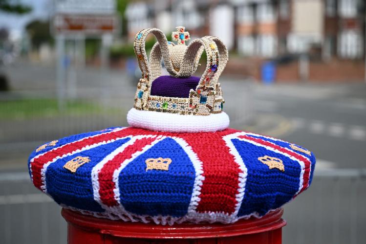 A_photograph_taken_on_May_2_2023_shows_a_knitted_crown_displayed_on_a_post_o