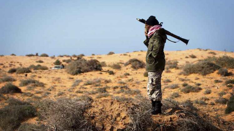 A Libyan rebel soldier stands with an RPG near a check point