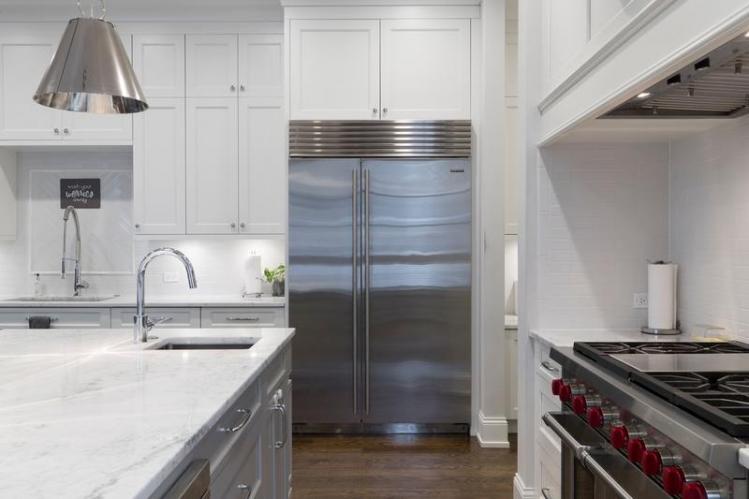 stainless-steel-refrigerator-beside-white-kitchen-cabinet-2343467.jpg