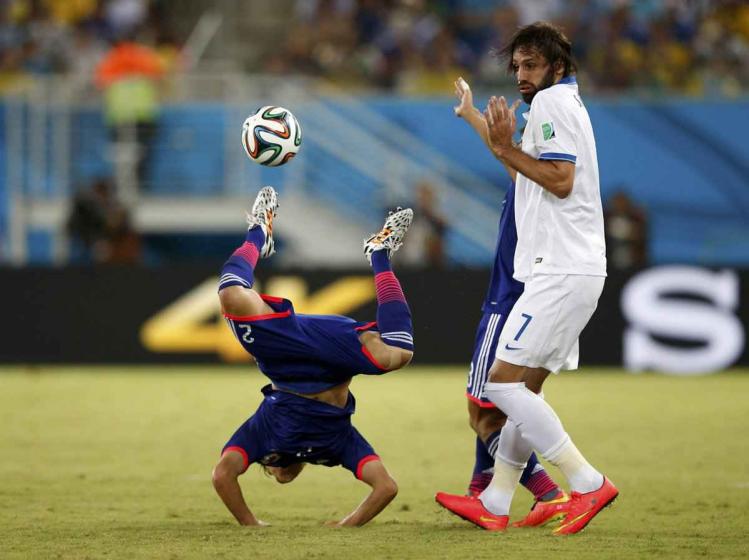 japans-atsuto-uchida-does-a-handstand-during-a-game-against-greece.jpg