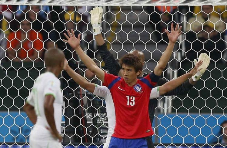 south-koreas-koo-ja-cheol-celebrates-his-goal-as-alergias-defenders-raise-their-arms-in-disbelief.jpg