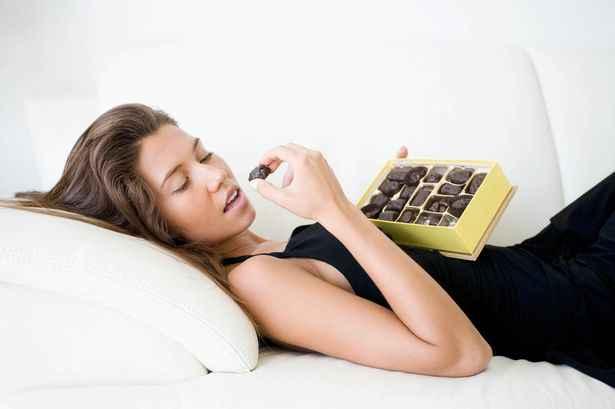 Woman-eating-chocolates-1280917.jpg