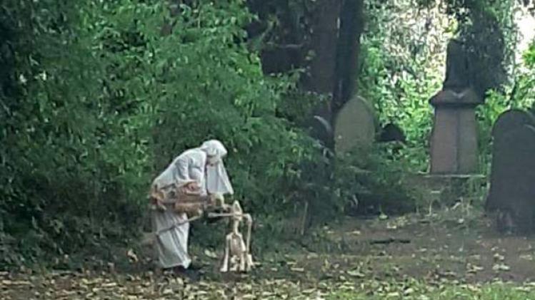 0_Woman-dressed-as-nun-seen-dancing-with-skeleton-outside-graveyard (2)