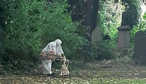0_Woman-dressed-as-nun-seen-dancing-with-skeleton-outside-graveyard (2)